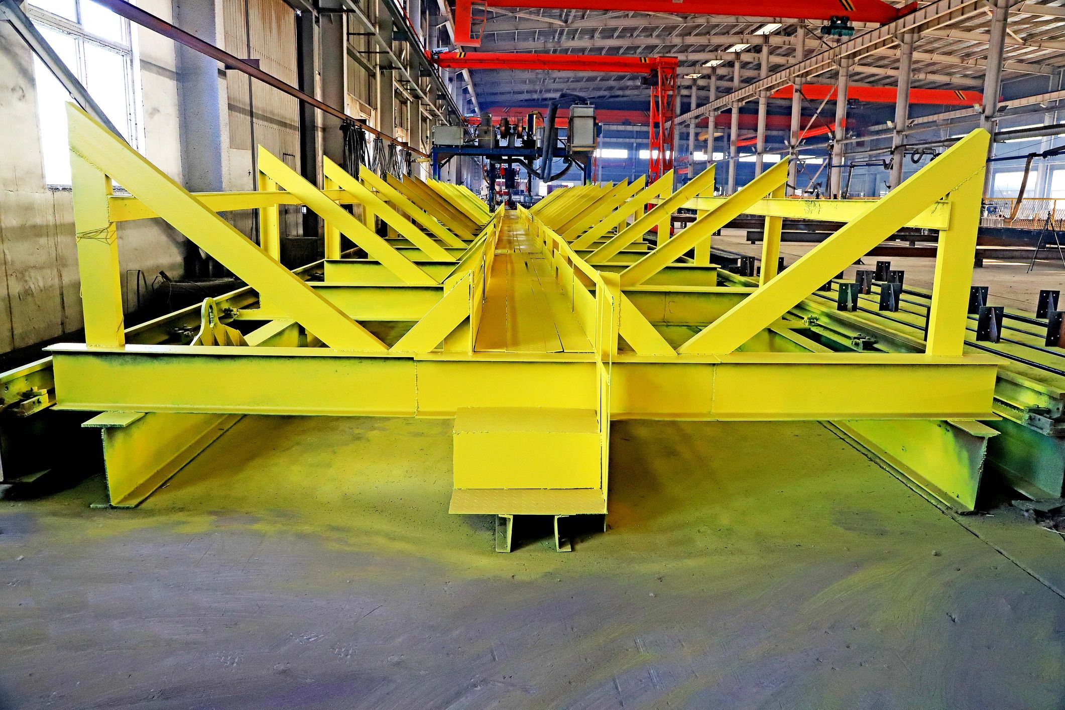 Steel fabrication facility with structural frames and overhead equipment