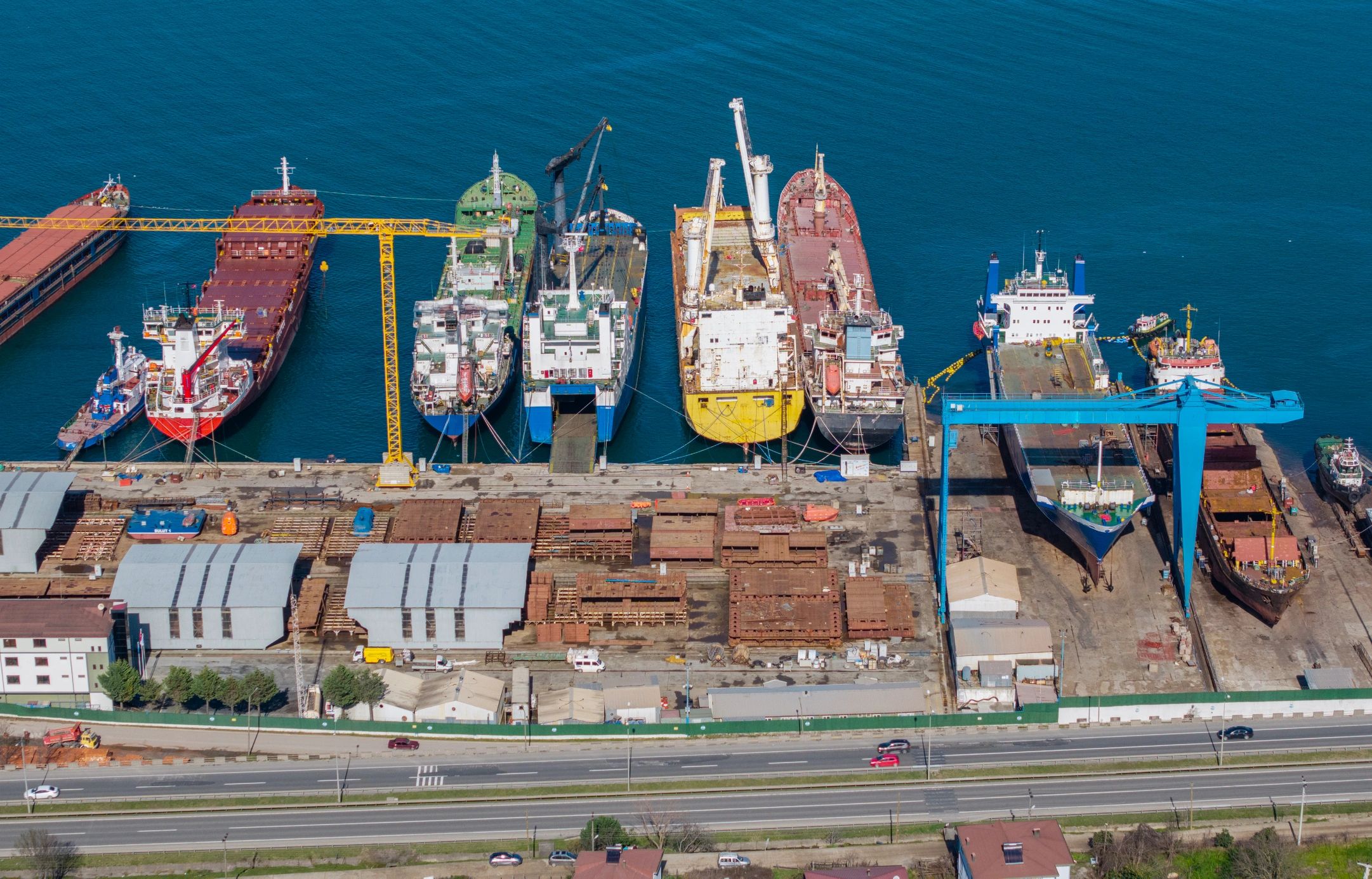 Shipyard with cranes and vessels under maintenance