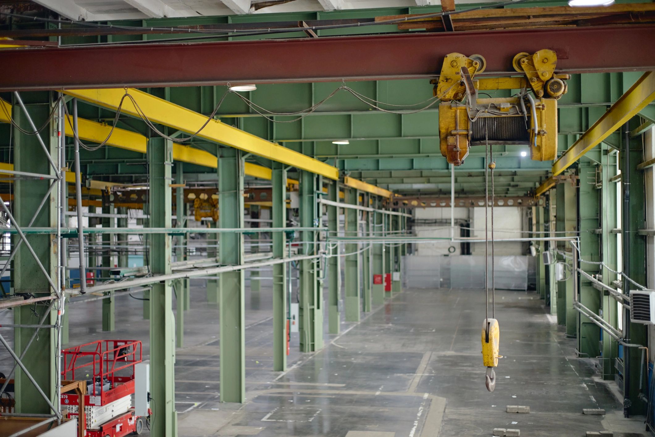 Wide interior view of an industrial facility with an overhead crane