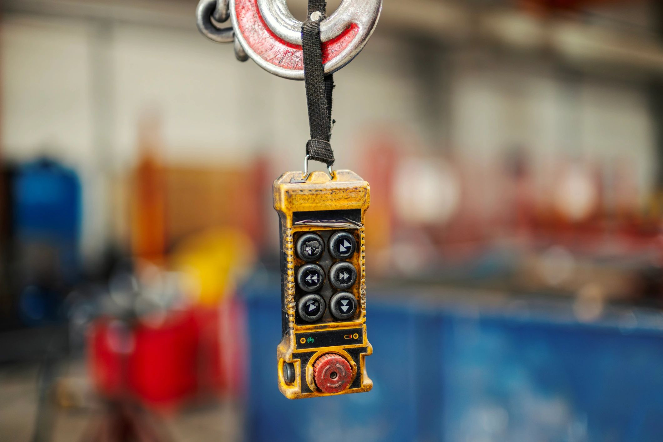 Industrial crane pendant control hanging in a workshop